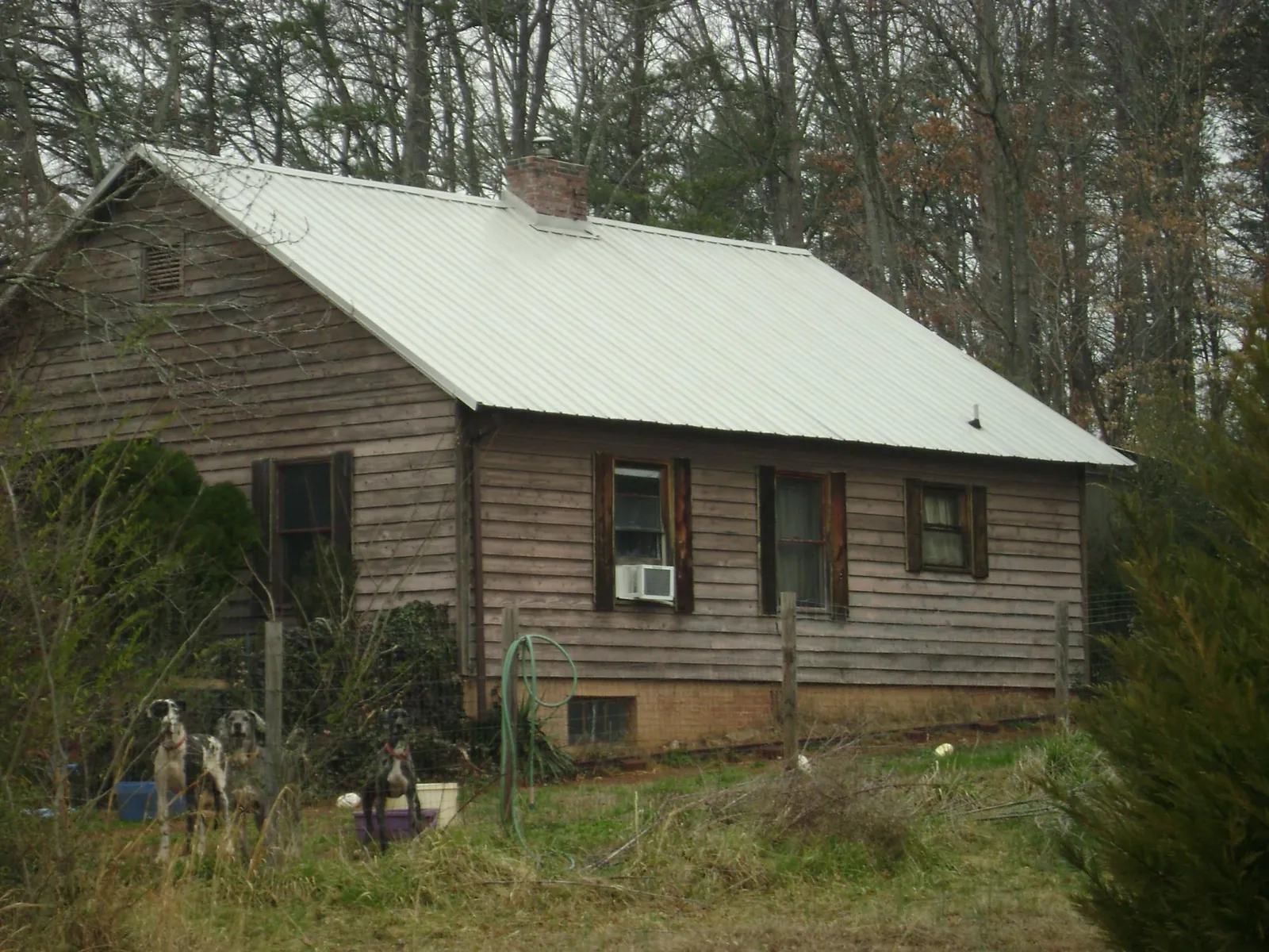White metal roof on an old wood sided farmhouse, from a Metal Roof Installation job in Henry